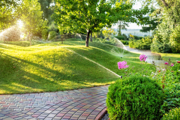 Smart garden with automated sprinklers watering a well-maintained lawn and vibrant flowers.